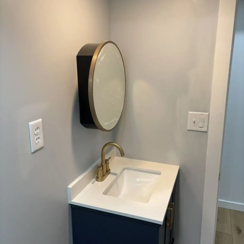 Custom Bathroom Remodel with New Marble Counters and Navy Cabinetry